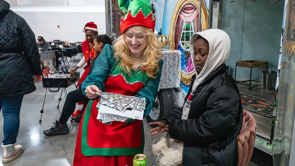 Santa's elf sharing activity pages with child